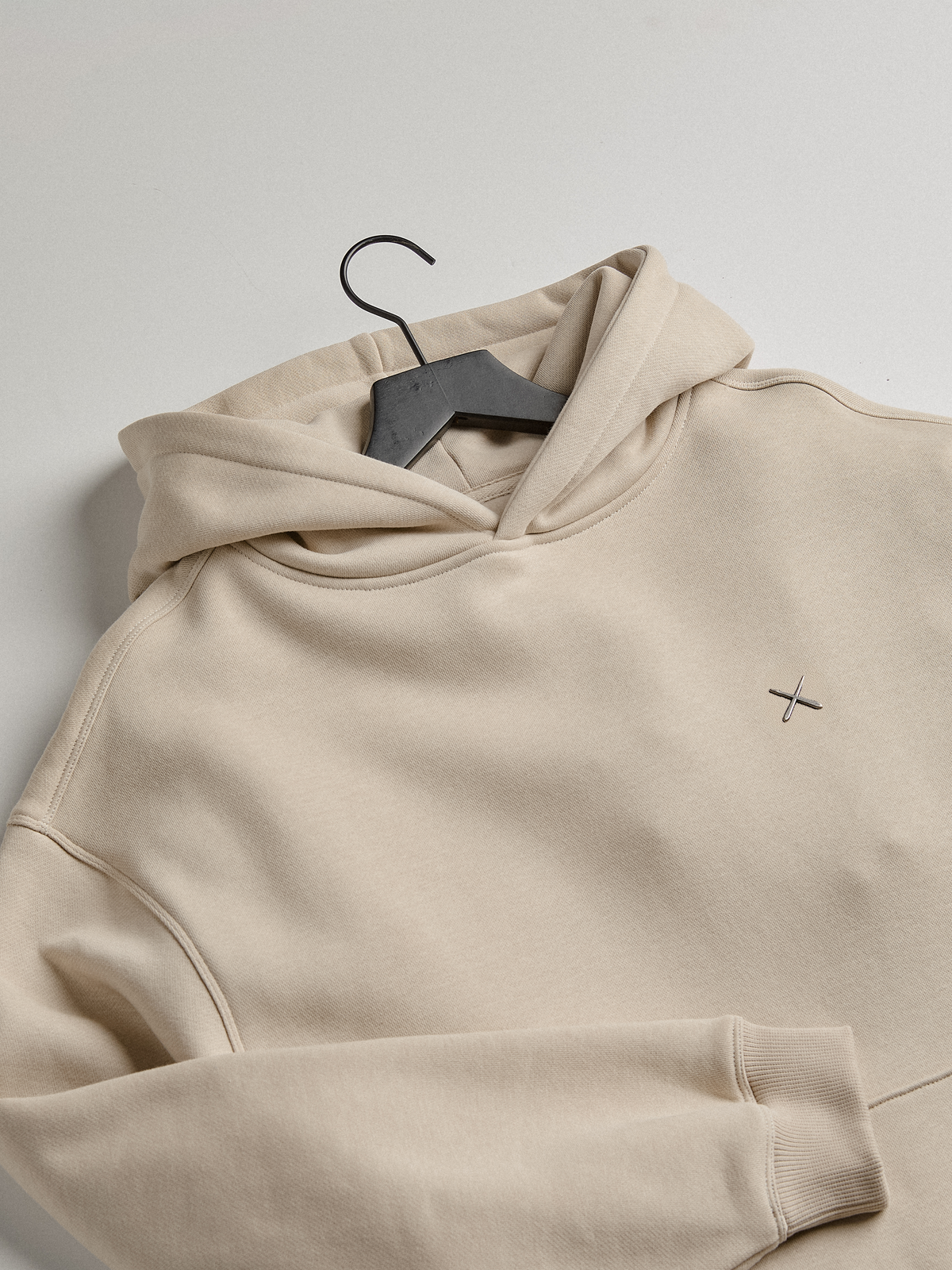 Off-white fleece hoodie on a hanger